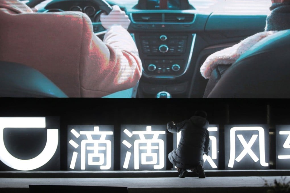 A man is seen in front of a Didi Chuxing sign in Beijing before a promotional event for the company’s Hitch car-pooling service in January this year. Photo: Reuters