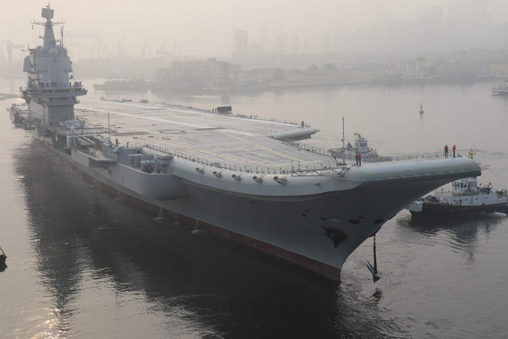 China's first domestically manufactured aircraft carrier leaves port in the northeast city of Dalian, China early on Sunday. Photo: AFP