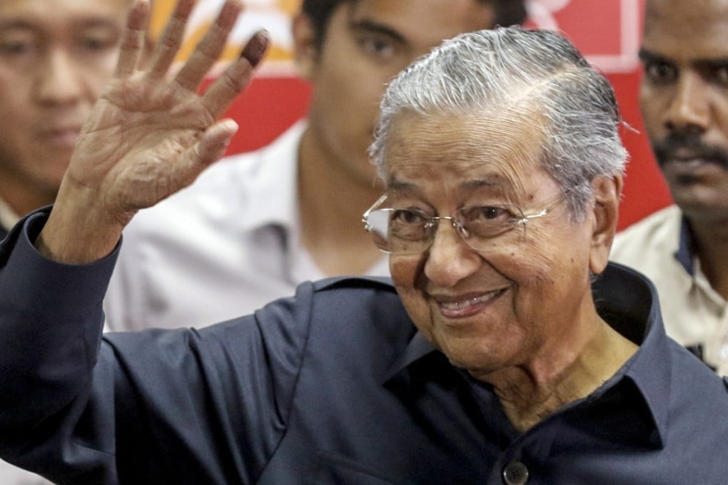 Malaysian Prime Minister Mahathir Mohamad waves at the end of a press conference in Kuala Lumpur. Photo: EPA