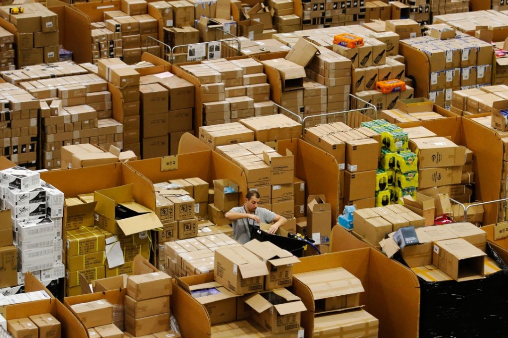 A worker picks an item for a customer's order at an Amazon.com fulfilment centre in Britain. Amazon wants to evolve from an e-commerce provider into a global logistics operation, helping merchants on its online platform connect directly with manufacturers in China. Photo: Bloomberg