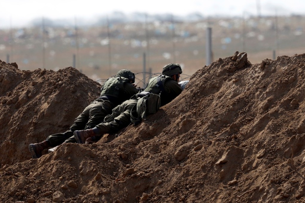 Israeli soldiers on the Israel side of the border fence near the Gaza Strip on Tuesday. Photo: Reuters