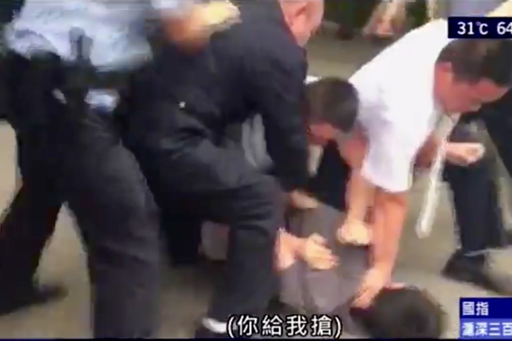 Screen capture from Now TV news shows Hong Kong video journalist Chui Chun-ming being wrestled to the ground, handcuffed and dragged onto a vehicle by police in Beijing while his crew tried to cover a hearing involving human rights lawyer Xie Yanyi on Wednesday morning. Photo: Now TV