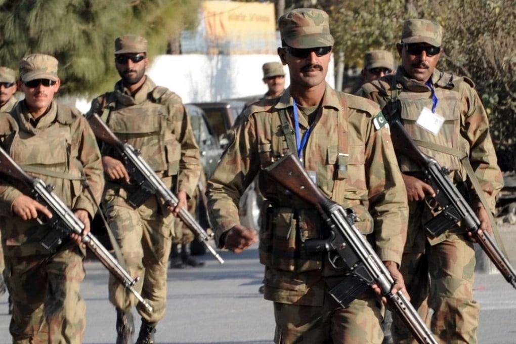 Pakistani soldiers take up position outside a besieged mosque in Pakistan's garrison city Rawalpindi on December 4, 2009. At least 30 people were killed when gunmen stormed the place of worship, detonating bombs and shooting at visitors, the interior minister said. AFP PHOTO/Farooq NAEEM