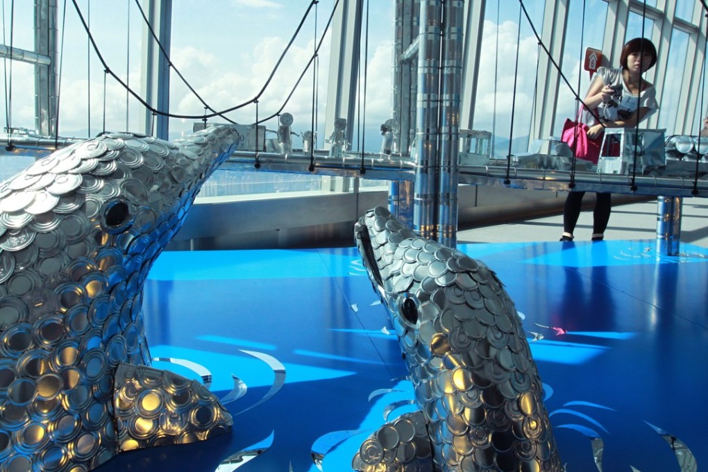 Chinese white dolphins are displayed in an exhibition of 3D sculptures of iconic Hong Kong features made with cans, at the International Commerce Centre observation deck, in West Kowloon in July 2012. Photo: May Tse