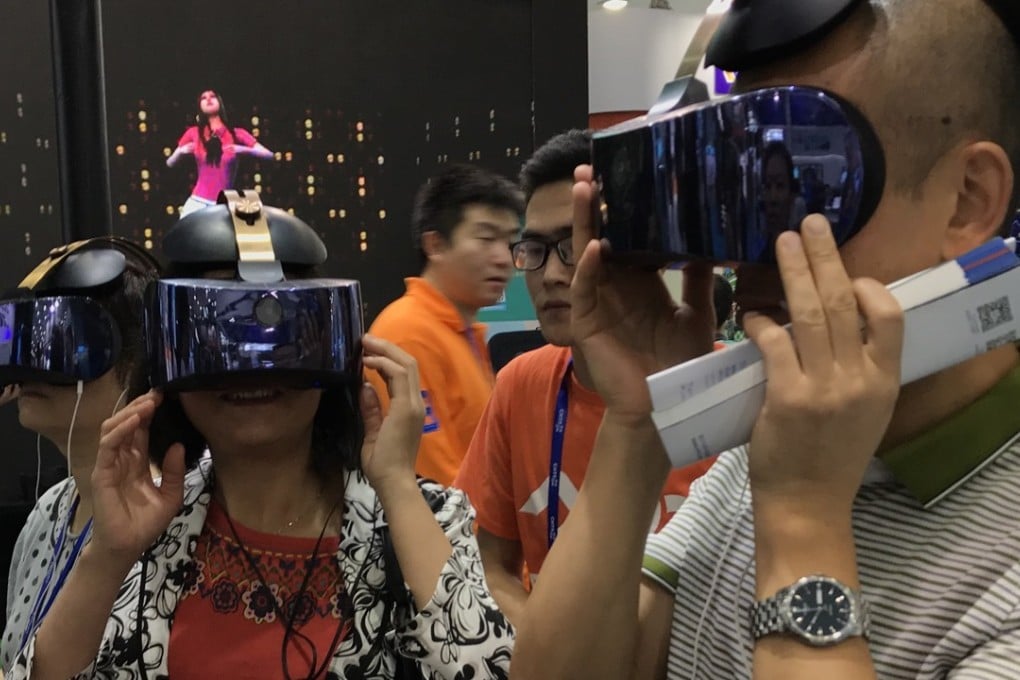 Participants at the China Hi-Tech Fair 2017, held in November in Shenzhen, try out the Qiyu virtual reality headset from iQiyi, a Netflix-style online video-streaming company controlled by Baidu. Photo: Handout