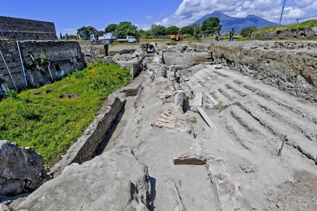 Archaeologists inspect excavation works in the archaeological site of Pompeii where they discovered a street of houses with intact balconies that were buried when Mt Vesuvius erupted in 79AD. Photo: AP