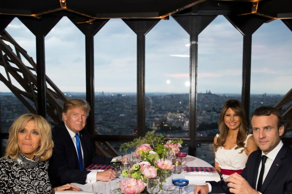 US President Donald Trump, first lady Melania Trump, French President Emmanuel Macron (Right, foreground) and his wife Brigitte Macron (Left, foreground) at a dinner on July 13, 2017 at the Jules Verne Restaurant at the Eiffel Tower in Paris. Photo: AP