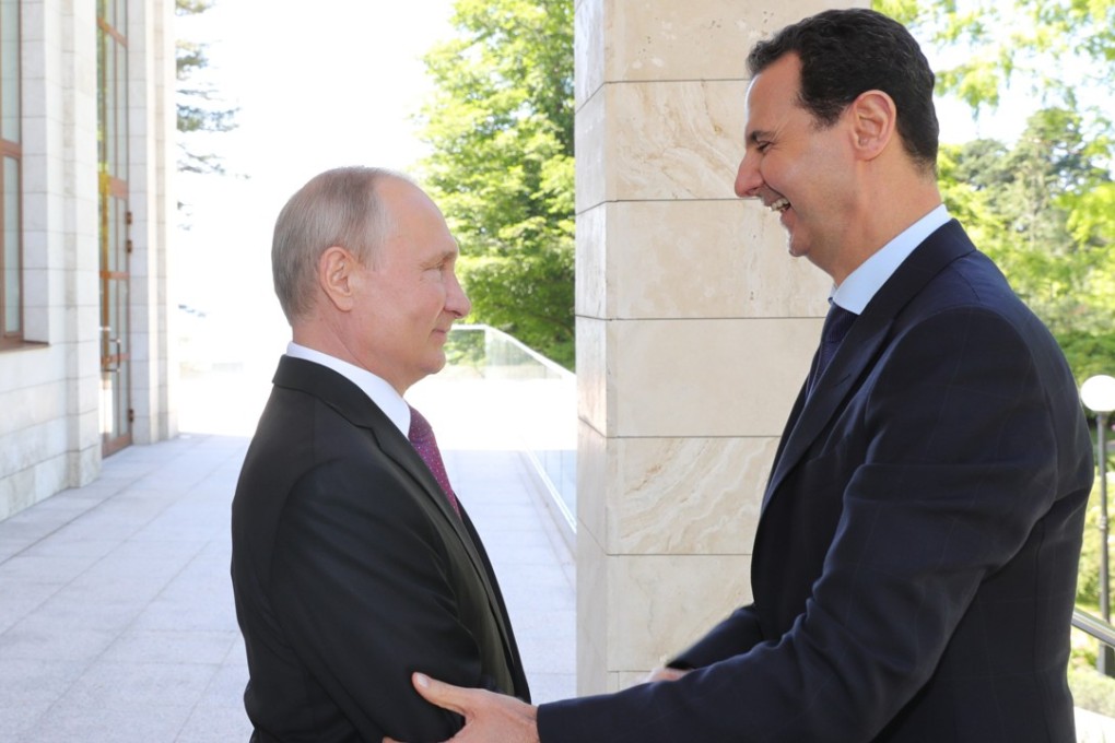 Russian President Vladimir Putin (left) shakes hands with Syrian President Bashar al-Assad during their meeting in the Black sea resort of Sochi on Thursday. Photo: EPA