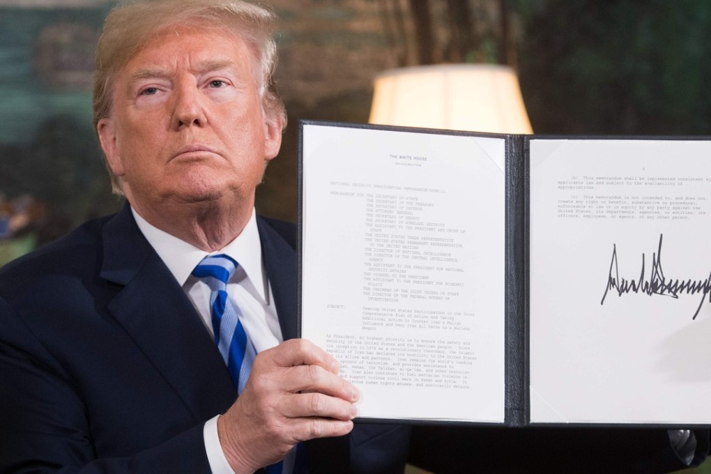 US President Donald Trump displays the document he signed reinstating sanctions against Iran, after announcing the American withdrawal from the Iran nuclear deal, at the White House on May 8. Photo: AFP