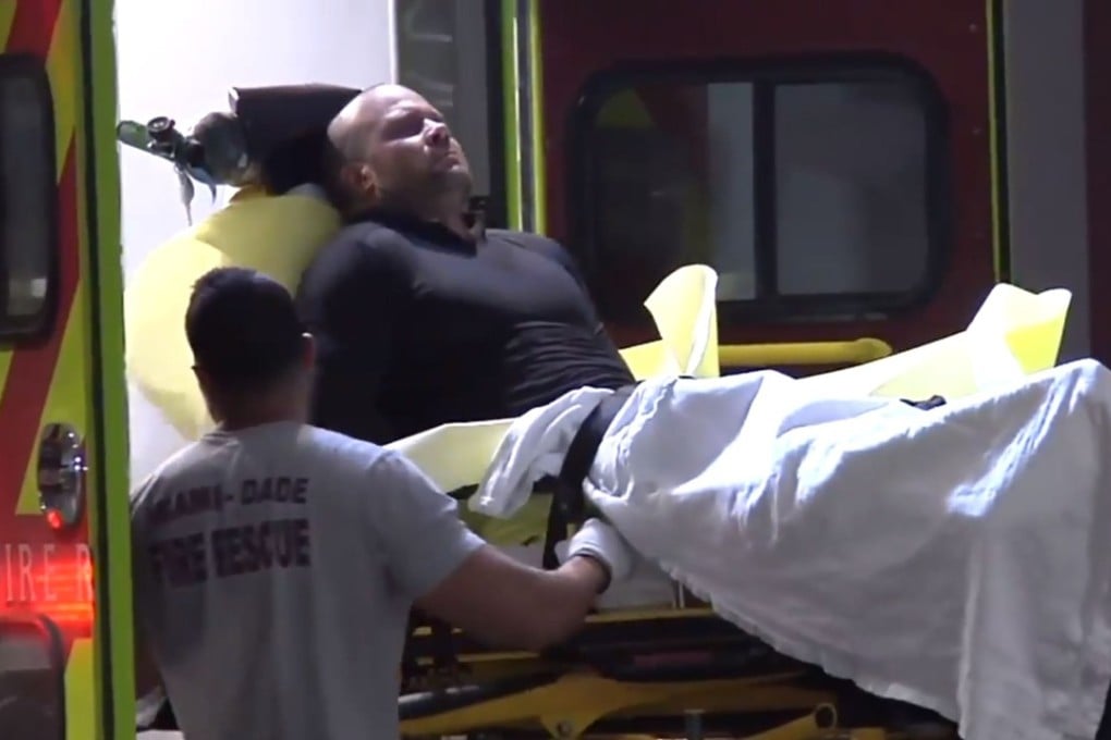 Jonathan Oddi is moved on a stretcher from an ambulance after a shoot-out near Miami early Friday. Photo: Miami Herald