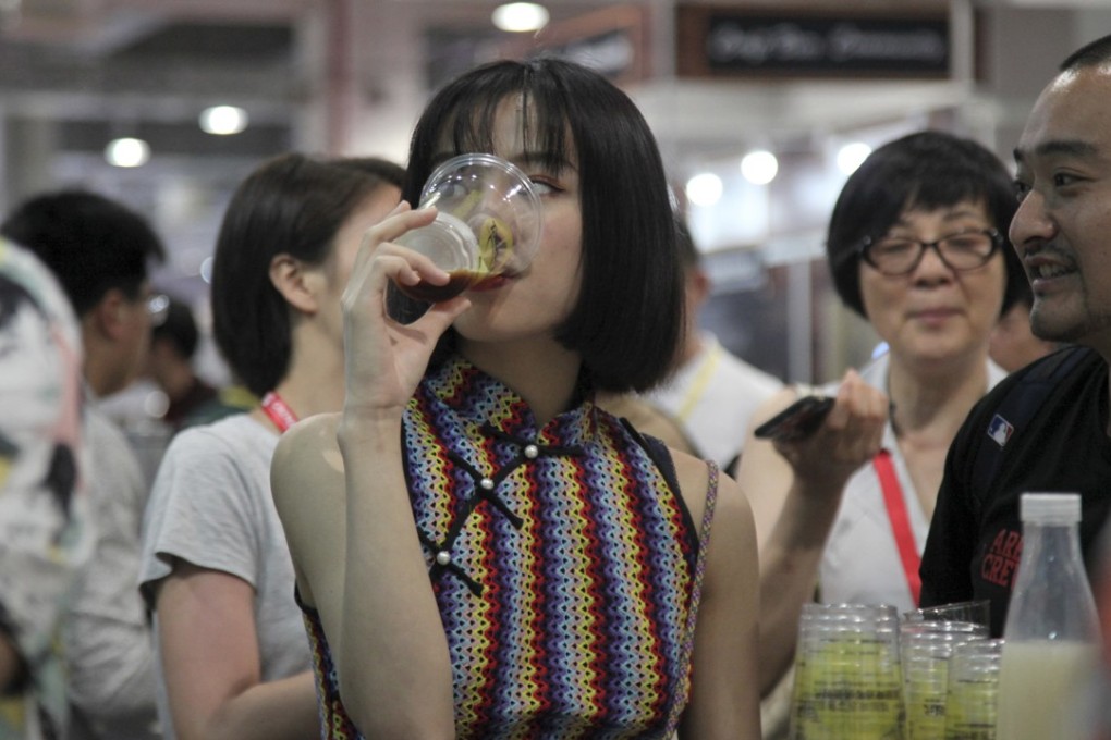 A woman drinks beer at the 2018 Craft Beer of China Exhibition in Shanghai, an event dedicated to expanding the palette of local consumers and promoting the sale of high-end brews. Photo: AP