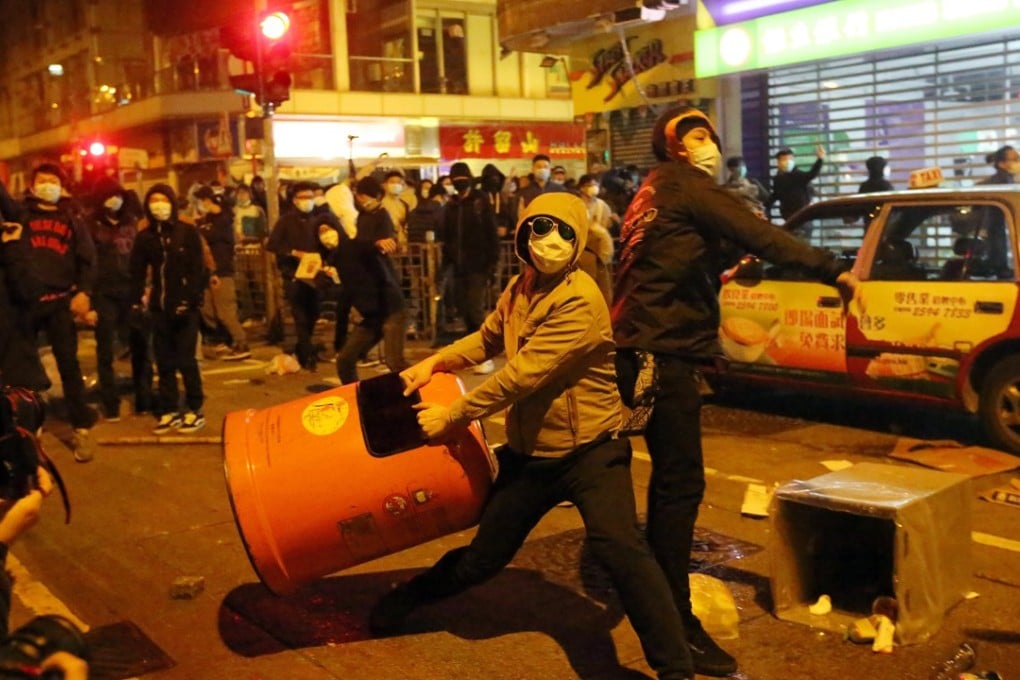 Masked rioters hurled rubbish bins and bricks at police officers during the clashes in Mong Kok. Photo: Edward Wong