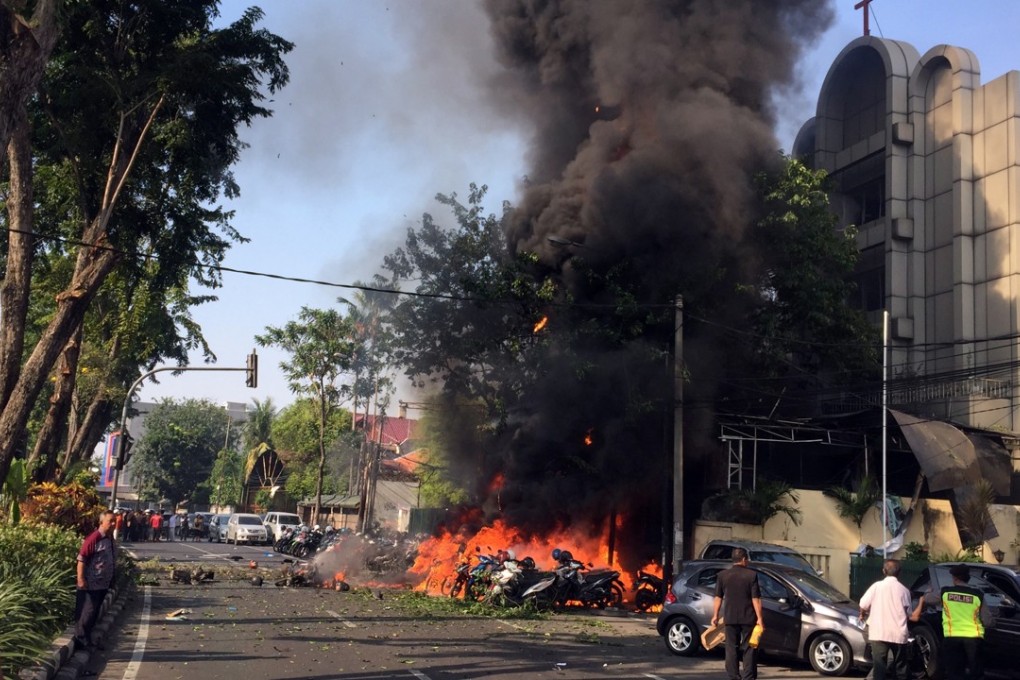 A handout photo made available by the Government of Surabaya shows a burning vehicles shortly after a bomb blast at a church in Surabaya, East Java, Indonesia, on May 13. Photo: Surabaya Government via EPA-EFE