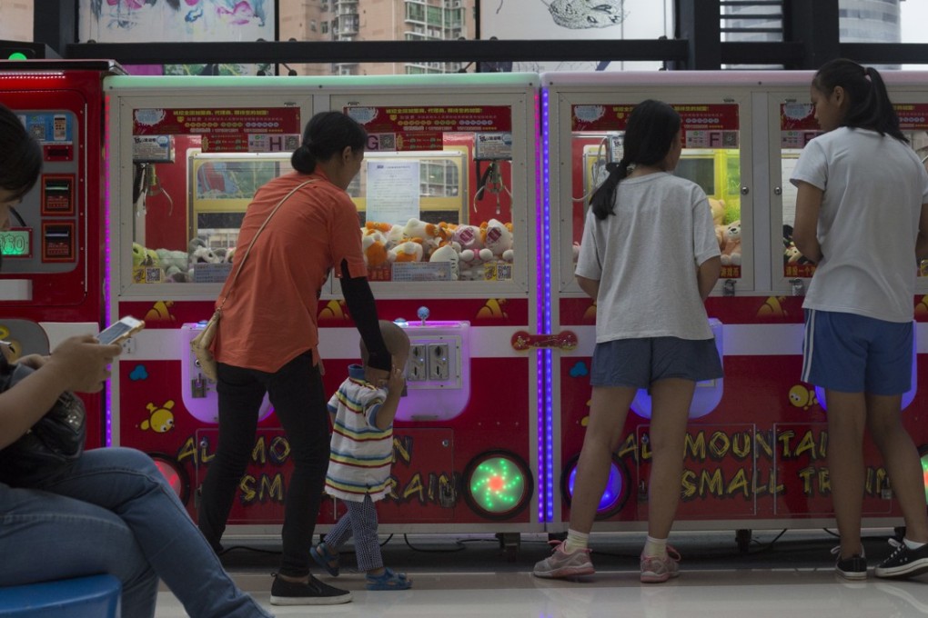 Chinese shoppers use mobile payments to pay for claw machines in Shenzhen, China. Photo: SCMP