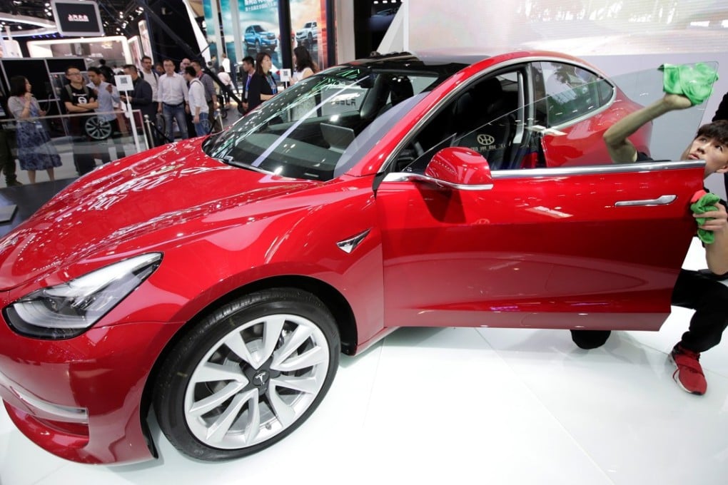 A man cleans a Tesla Model 3 car during a media preview at the Auto China 2018 motor show in Beijing last month. In a series of tweets over the weekend, Tesla chief executive Elon Musk unveiled specifications for a faster and more powerful version of the Model 3. Photo: Reuters