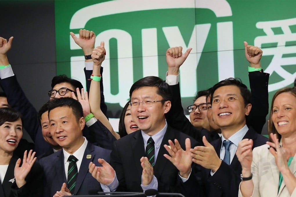 Yu Gong (center), Founder and CEO of China-based iQiyi,  rings the Opening Bell at Nasdaq MarketSite in Times Square with employees and investors in celebration of its initial public offering (IPO) on March 29, 2018 in New York City. Photo: AFP