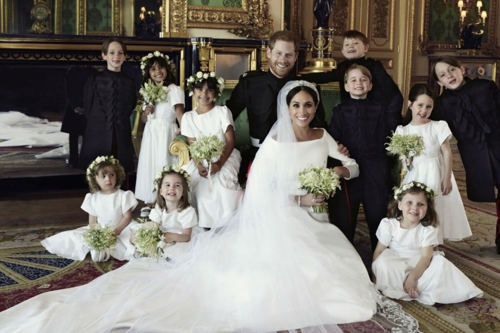 The official wedding photo of Britain’s Prince Harry and Meghan Markle, center, in Windsor Castle, Windsor, England on Saturday. Prince George is standing to the right of Markle; Princess Charlotte is seated second from left. Photo: Kensington Palace via AP