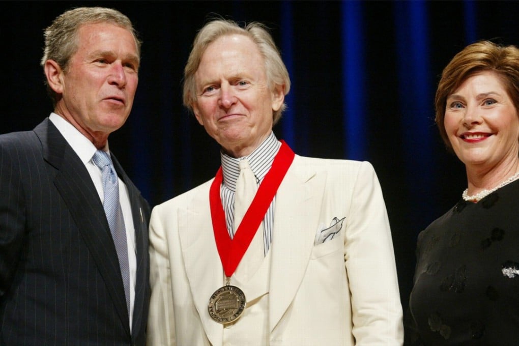 Author Tom Wolfe poses with then-president George W. Bush, and first lady Laura Bush during the National Endowment for the Arts National Medal Awards ceremony at Constitution Hall in Washington in 2002, where Wolfe was a recipient of the National Humanities Medal. Photo: AP