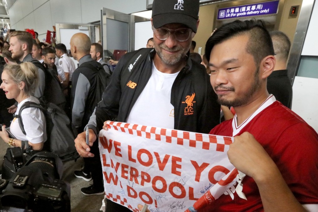 Liverpool manager Jurgen Klopp poses with a fan as the club arrive at Hong Kong International Airport ahead of the Premier League Asia Trophy last year. Photo: Felix Wong