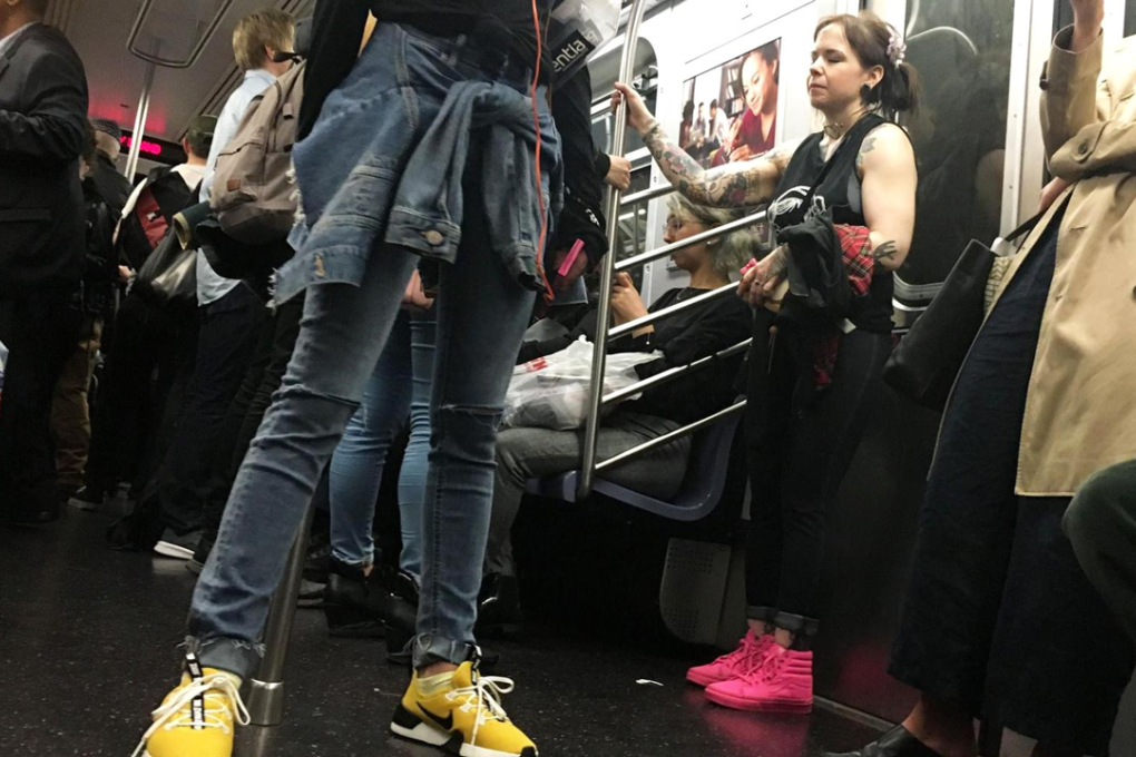 Even in large metropolitan areas, women are choosing comfortable footwear. Women ride the subway in New York City wearing a variety of sneakers and flats. Photo: Kellie Ell/CNBC