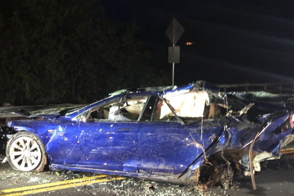 A Tesla Model S is shown after being pulled out of a pond on Monday near San Ramon, California. The driver, who was killed, veered off the road, crashed through a fence and into the pond, authorities said. Photo: KNTV via AP