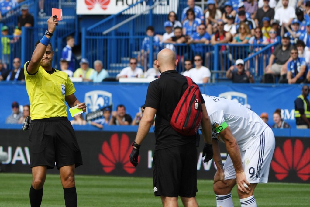 Los Angeles Galaxy forward Zlatan Ibrahimovic (right) is shown a red card after slapping a Montreal Impact player at Stade Saputo. Photo: USA Today