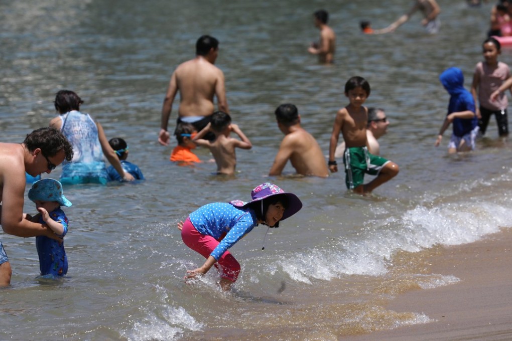 Families splash around at the Repulse Bay beach on May 6, during a spell of hot weather. Photo: Edward Wong