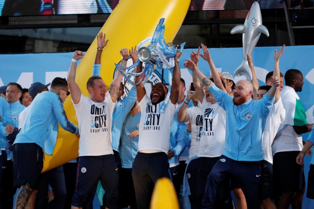 Manchester City players celebrate with the Premier League title on their winner’s parade. Photo: Reuters