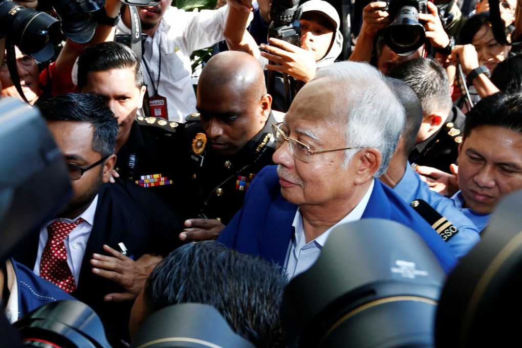 Scandal-tainted former prime minister Najib Razak is met by a media scrum as he arrives to give a statement to the Malaysian Anti-Corruption Commission, in Putrajaya on May 22. Photo: Reuters