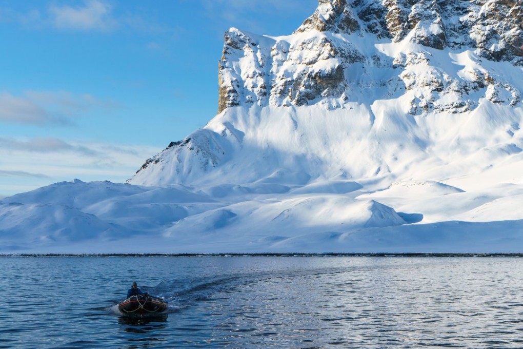 Robert Wolting, first mate of the Arctic expedition sailing ship Noorderlicht, returns in a Zodiac boat from reconnoitring a landing on Alkhornet mountain in Spitsbergen, Norway. Photo: Tessa Chan