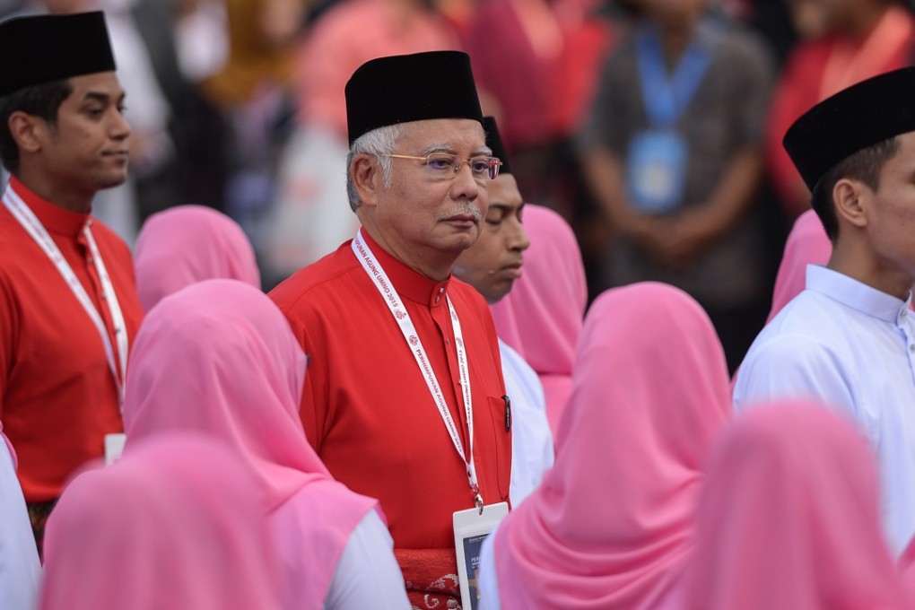 Najib Razak, then prime minister of Malayisa and president of the ruling United Malays National Organisation (Umno), inspects a ceremonial guard of honour during the party’s annual congress in Kuala Lumpur, on December 10, 2015. Photo: AFP