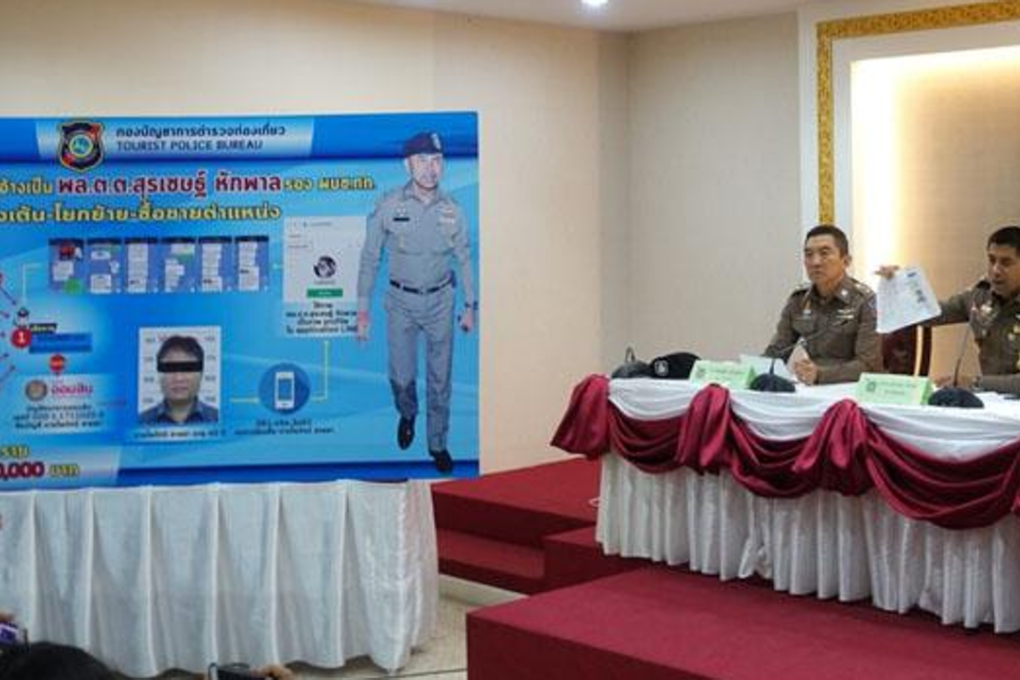 Pol Maj Gen Surachate Hakparn, right, deputy commissioner of tourist police, explains the "Big Joke" imposter case to reporters at the Royal Thai Police Office on Tuesday. A taxi driver pretending to be him was given more than 5 million baht (US$156,000) in bribes by officers wanting promotions. Photo: Thai tourist police