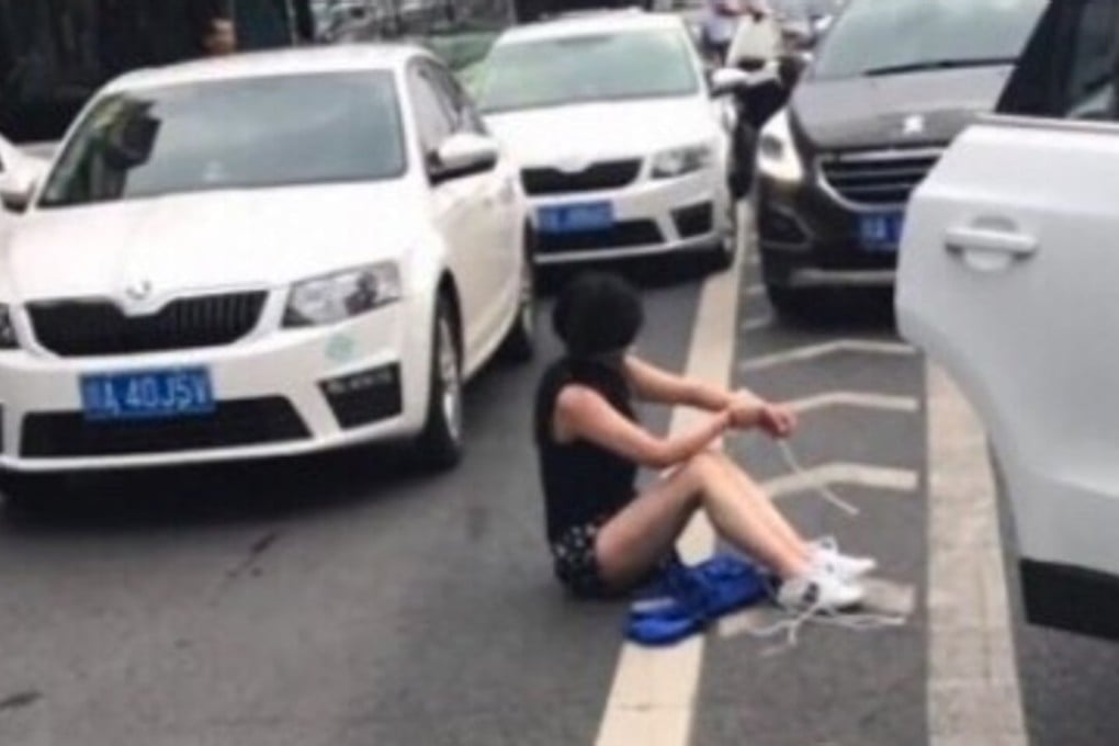 The woman, bound by the wrists and ankles, was seen sitting in the road after the accident. Photo: sina.com