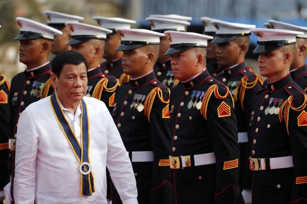 Philippines President Rodrigo Duterte reviewing honor guards during the 120th anniversary celebration of the Philippines navy on Tuesday. Photo: EPA-EFE