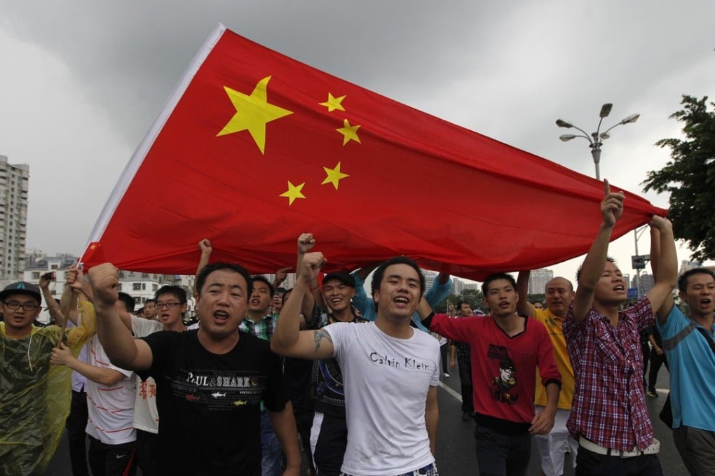 Protesters in Shenzhen carry a Chinese flag at an anti-Japan protest in Shenzhen. Photo: Reuters