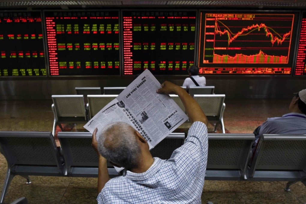 An investor reads a newspaper at a securities company in Beijing in June 2017. The inclusion of Chinese stocks in the MSCI indices is expected to attract at least US$18 billion in foreign capital. Photo: AFP