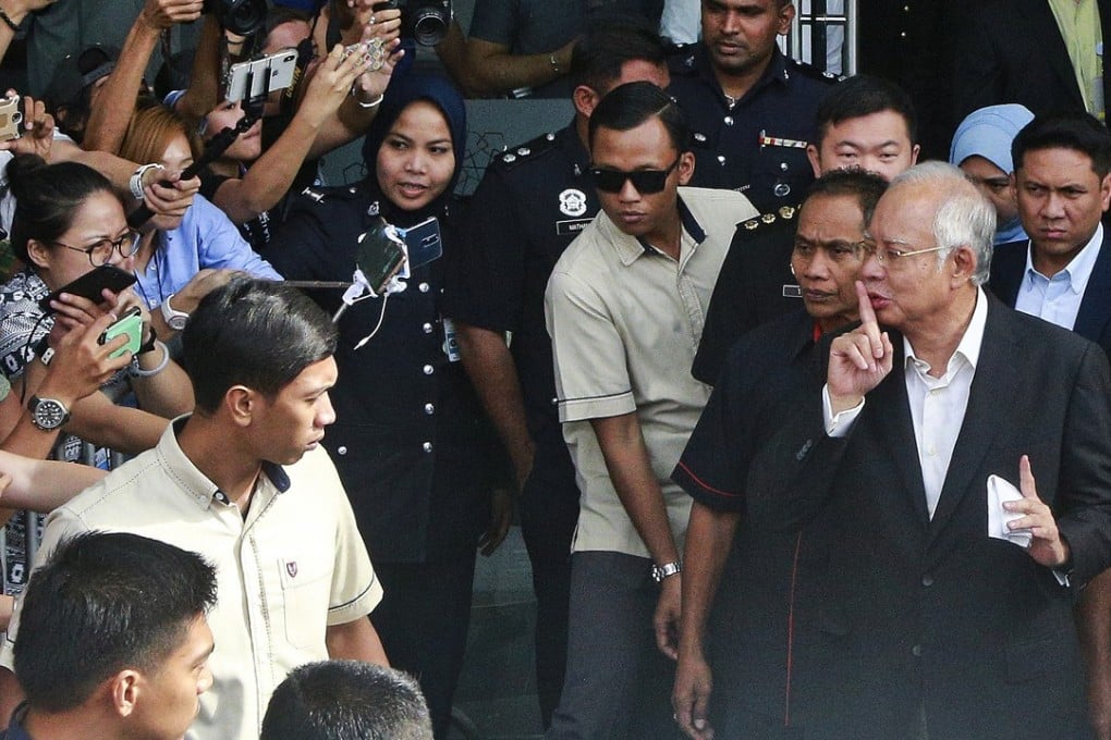 Former Malaysian Prime Minister Najib Razak leaves the Malaysian Anti-Corruption Commission office. Photo: AP
