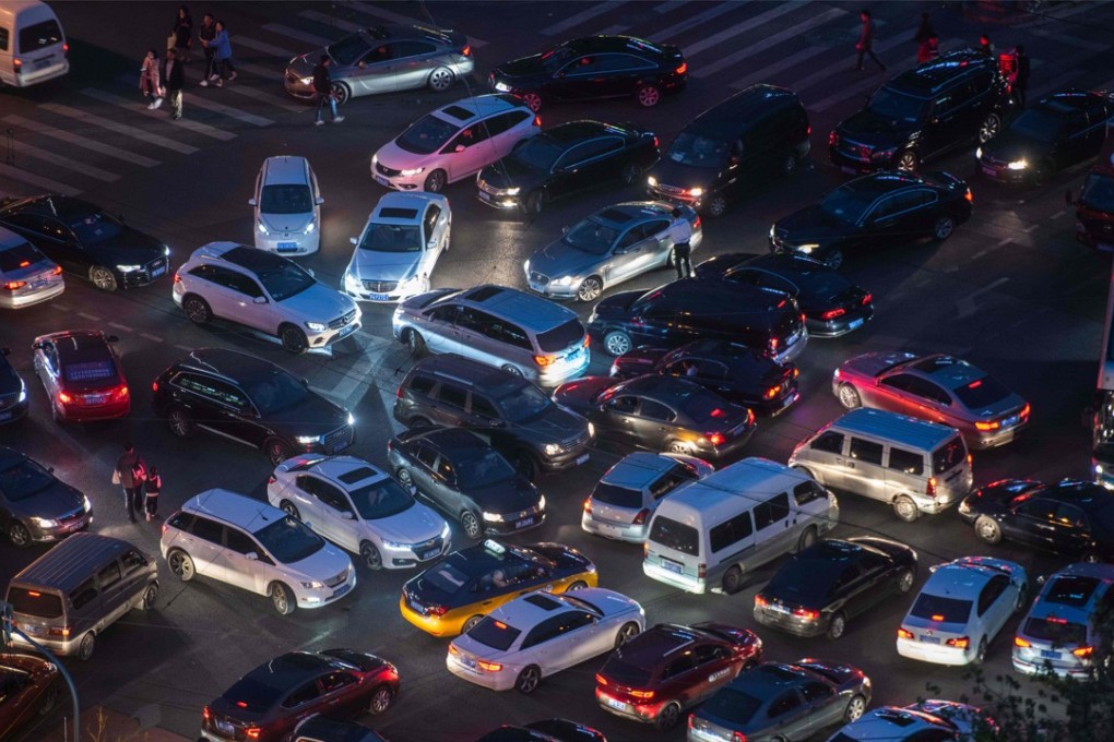 This picture taken on April 16, 2018 shows a traffic jam at a crossroad in the city centre of Beijing. / AFP PHOTO / Fred DUFOUR