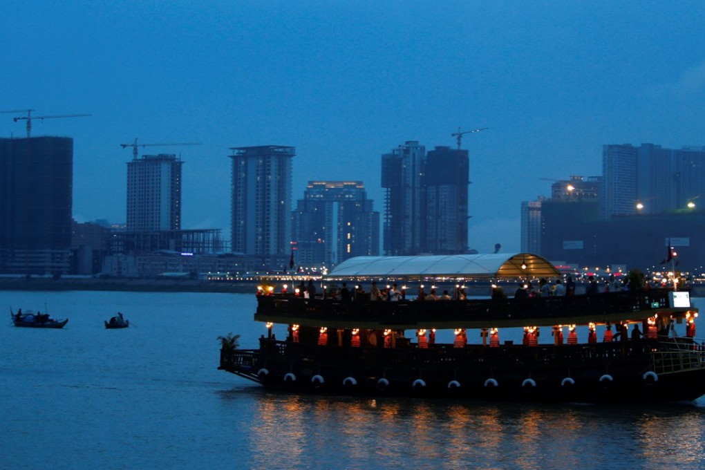 A boat passes buildings under construction on Diamond Island also known as 'Koh Pich', as seen from the Tonle Chaktomuk river in Phnom Penh. Photo: Reuters