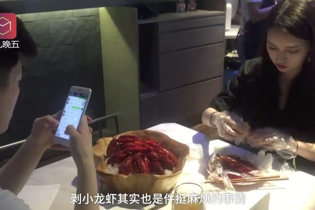 A peeler prepares crayfish for a customer who is busy messaging. Photo: Handout