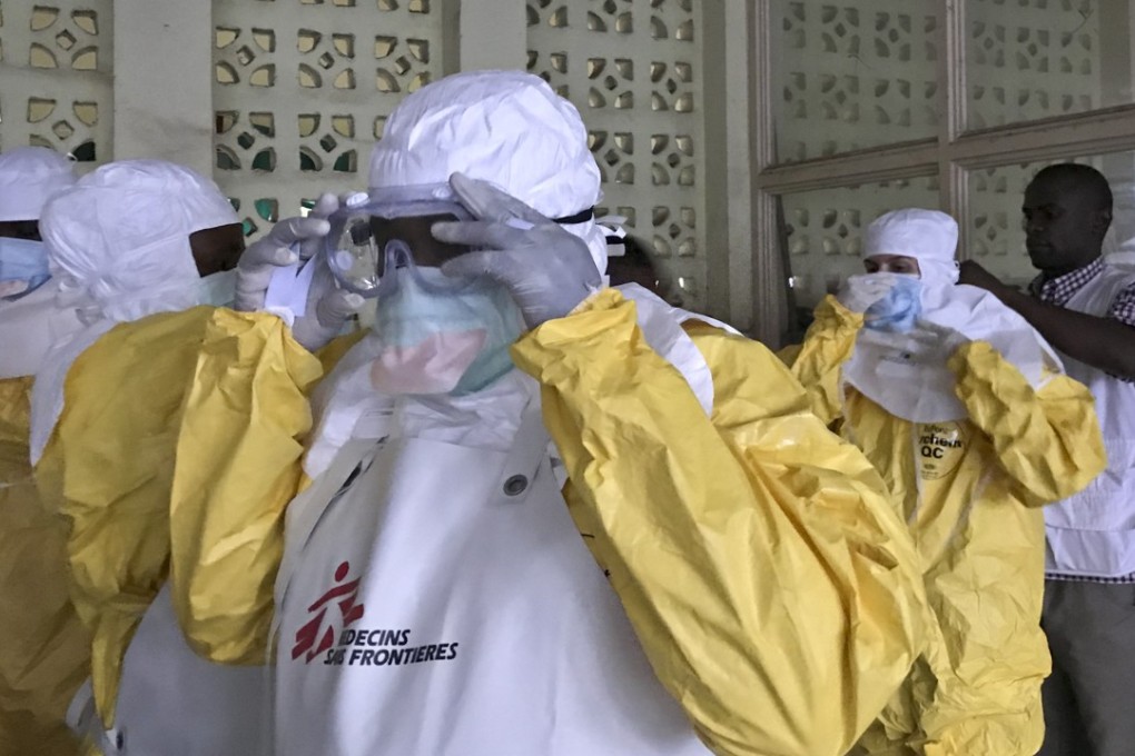 In this photo taken Sunday, a team from Medecins Sans Frontieres dons protective clothing as they prepare to treat Ebola patients in an isolation ward of Mbandaka hospital in Congo. Photo: AP