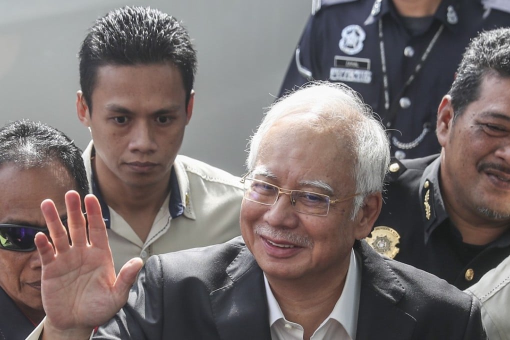 The embattled 64-year-old Najib Razak appeared relaxed, smiling and waving as he walked through a throng of journalists. Photo: EPA
