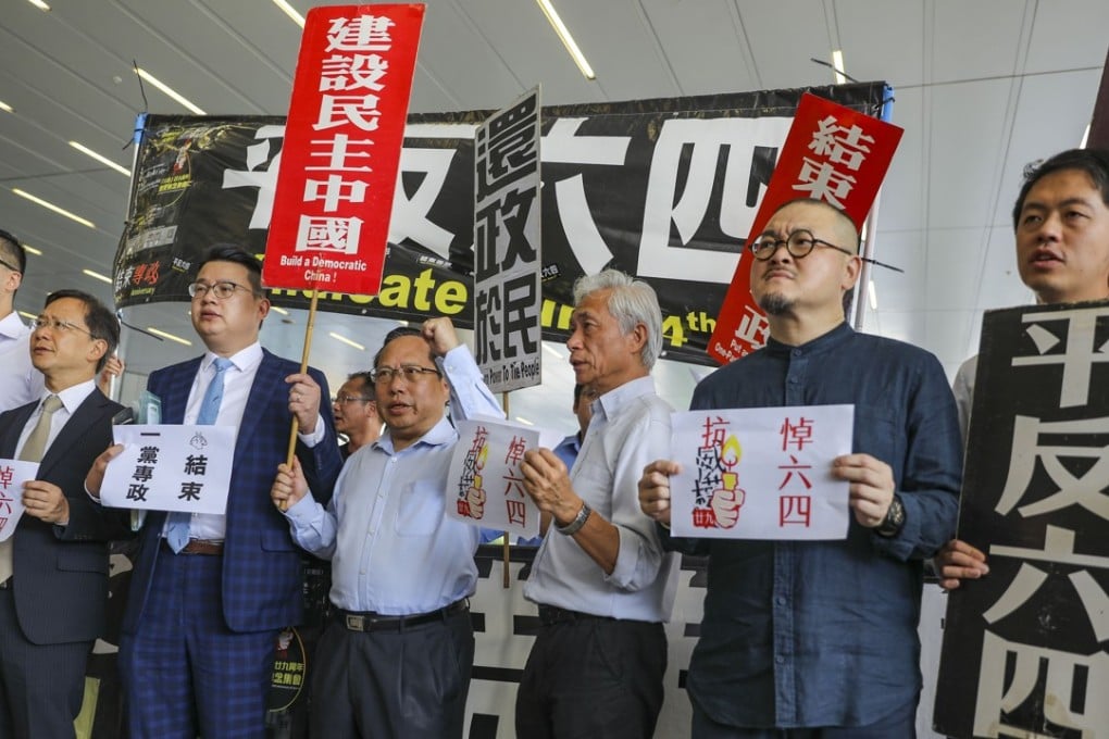 Pan-democrats outside the Legco building with flags and banners on Wednesday to support Tanya Chan’s motion. Photo: Sam Tsang