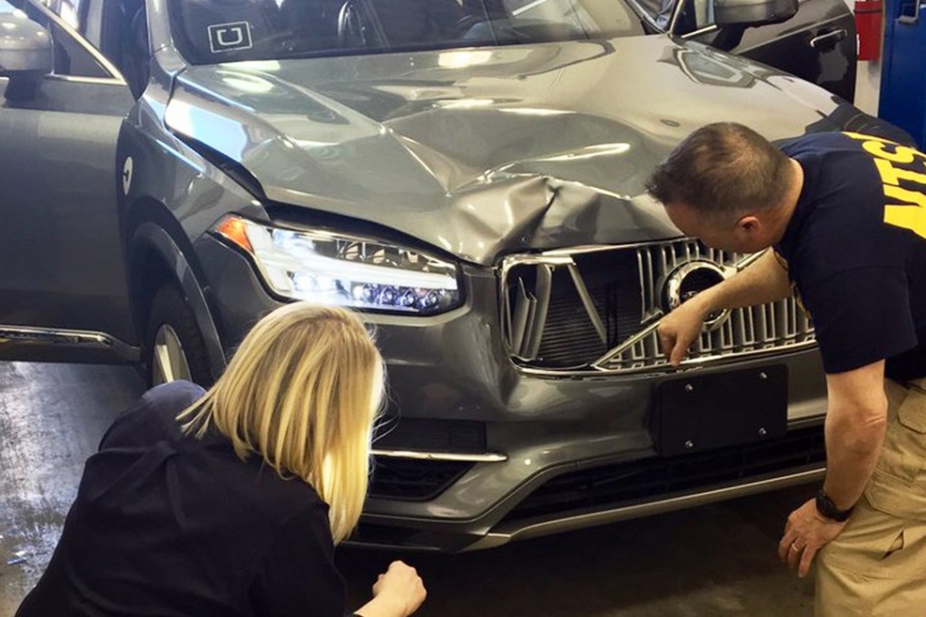 In this March 20 photo provided by the US National Transportation Safety Board, investigators examine a driverless Uber SUV that fatally struck a woman in Tempe, Arizona. Photo: National Transportation Safety Board via AP