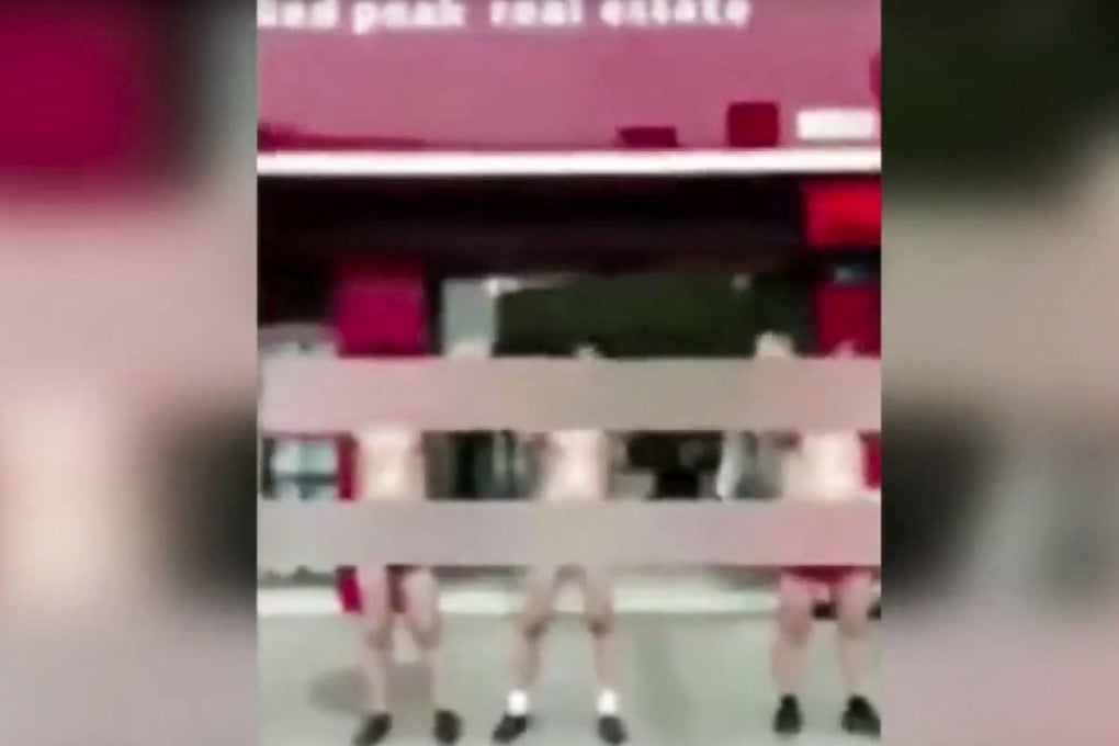 A property company in eastern China made four of its agents dance in the street in their underwear after accusing them of having a poor attitude towards customers. Photo: YouTube