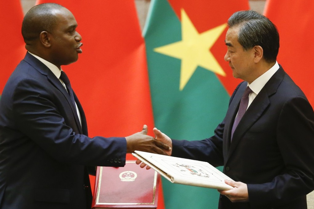 Chinese Foreign Minister Wang Yi shakes hands with his Burkina Faso counterpart Alpha Barry during a signing ceremony establishing diplomatic ties on Saturday. Photo: AP