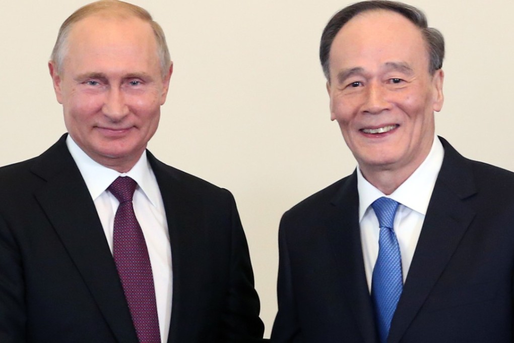 Chinese Vice-President Wang Qishan meets Russian President Vladimir Putin in St Petersburg on Thursday. Photo: Xinhua