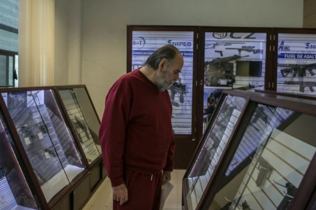 A customer walks the aisles of the Directorate of Arms and Munitions Sales in Mexico City. Prospective buyers must present at least six forms of identification, including proof of employment, and have a clean criminal record. Photo: TNS
