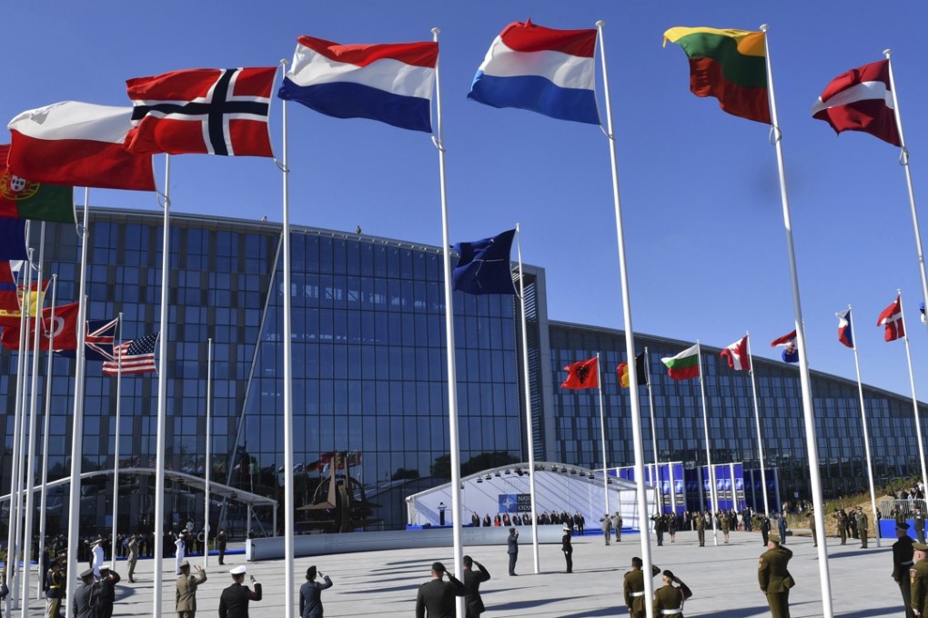 Flags of Nato member countries flutter outside a summit in Brussels. Photo: AP