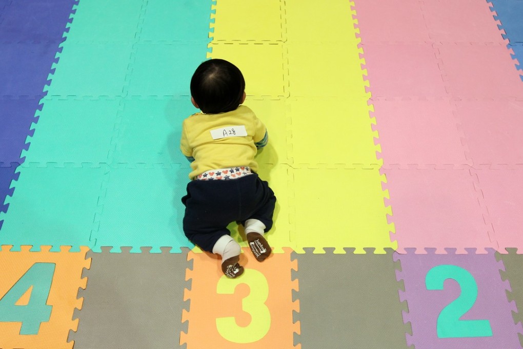 A 10-month old baby during a crawling contest at the Spring & Child Growth Education Expo at the Hong Kong Convention and Exhibition Centre. Photo: SCMP